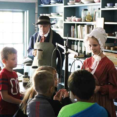 historical store with people in historical outfits